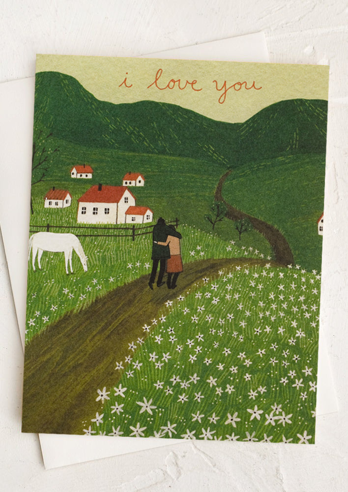 1: A card with illustration of couple walking through the countryside, text reads "I love you".