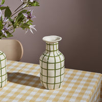 2: A ceramic vase in white with green grid pattern.