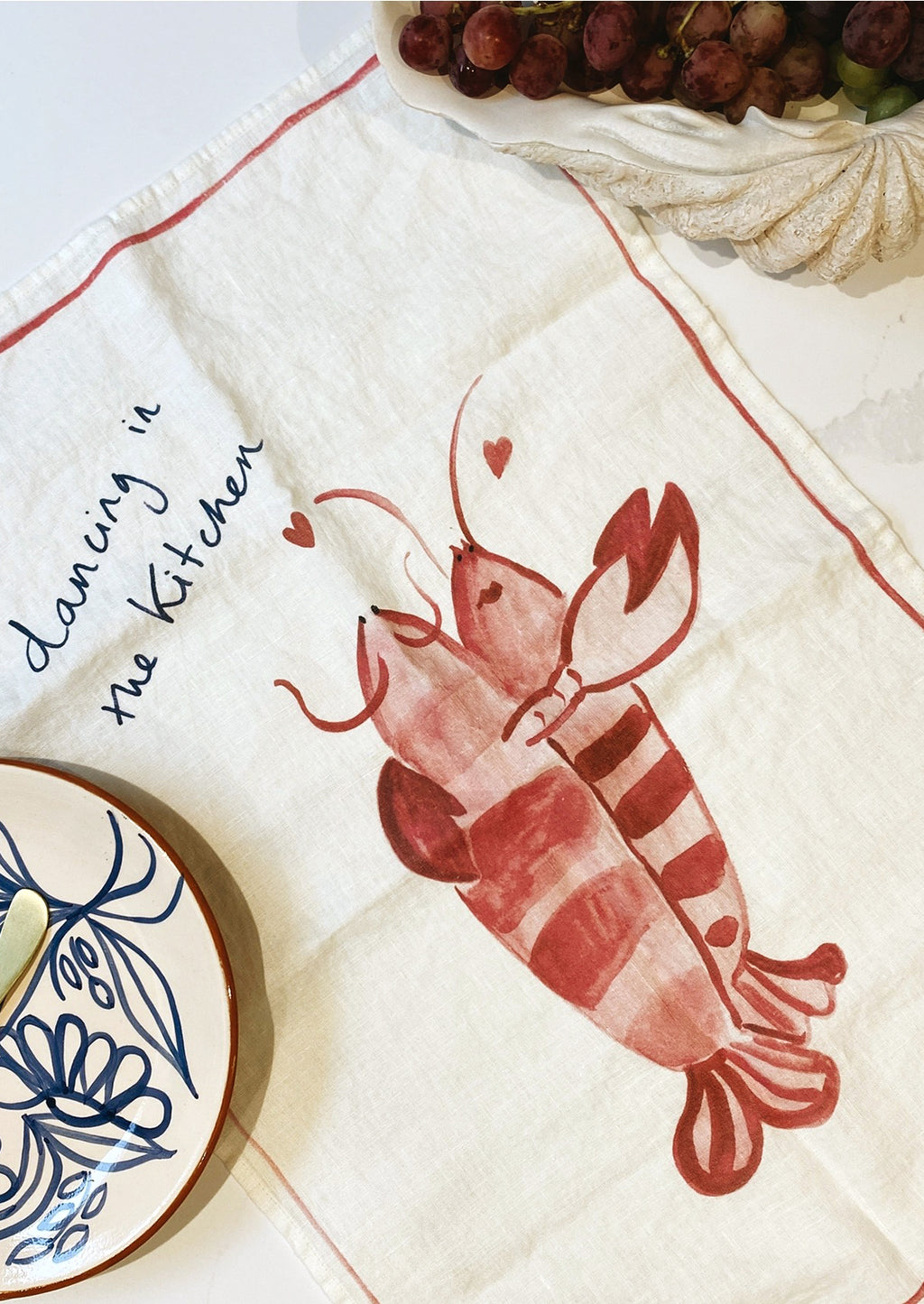 Kitchen Dancing: A white linen tea towel with lobster graphic and text.