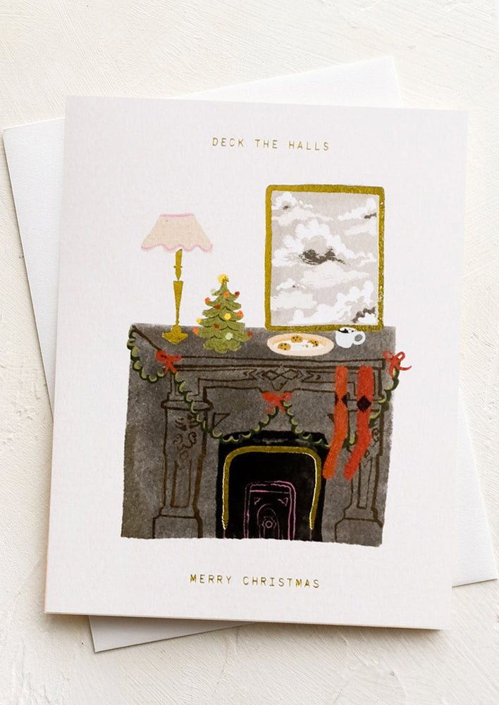 A greeting card with illustration of a decorated mantle and text reading "Deck the halls, merry christmas".