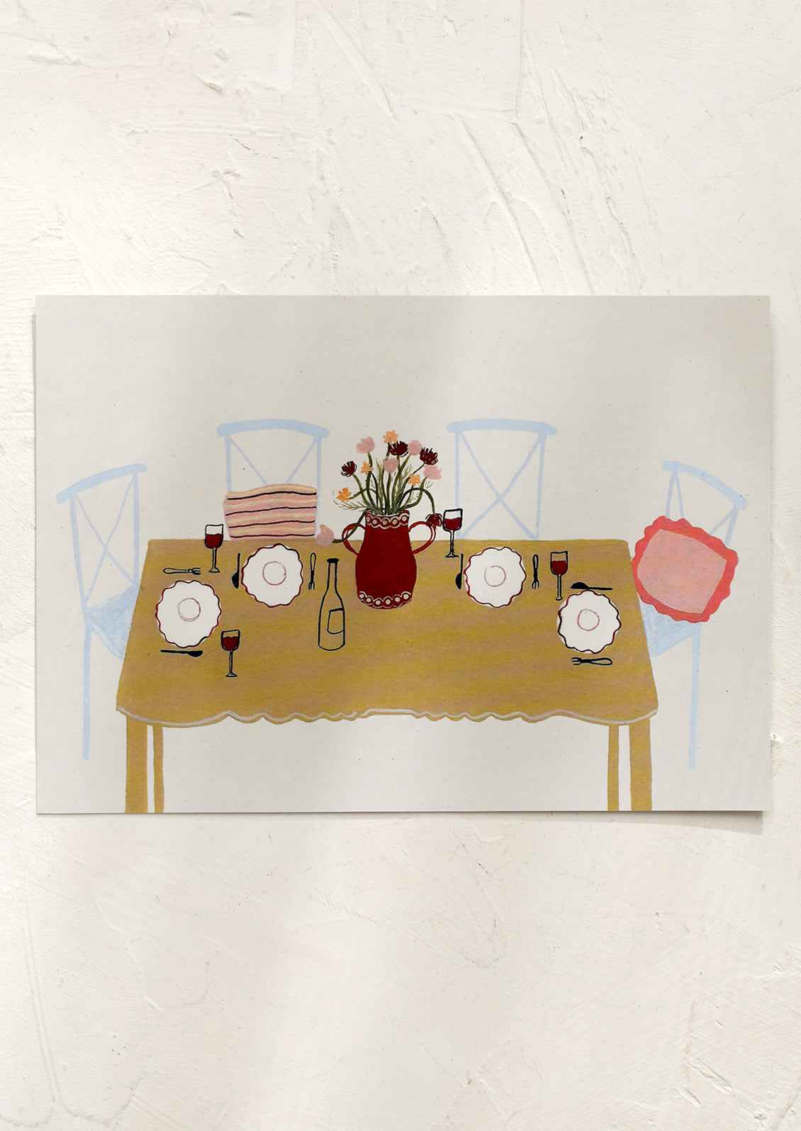 An art print of chairs around a table set for dinner.