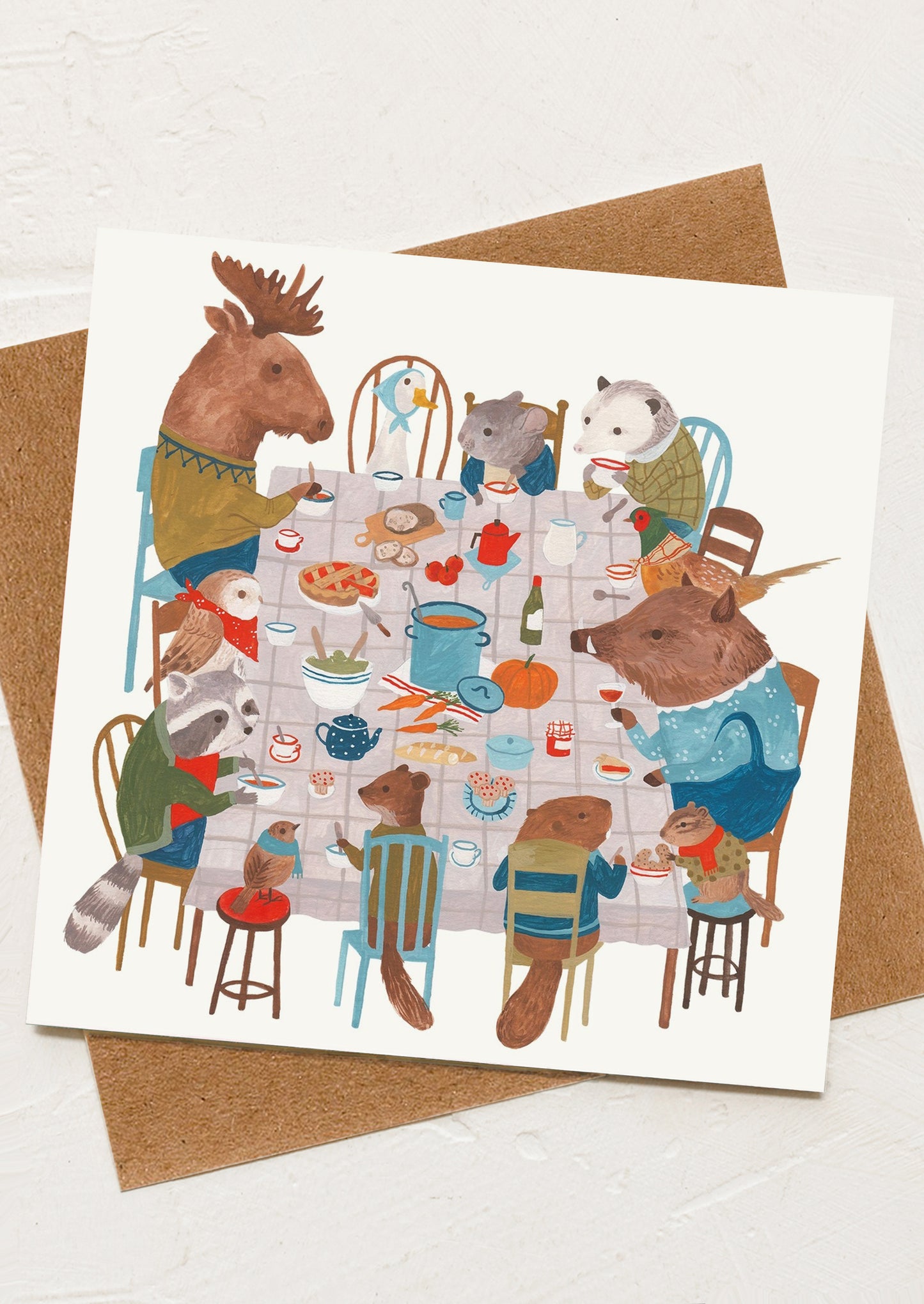 A greeting card with illustration of animals at a dinner party.