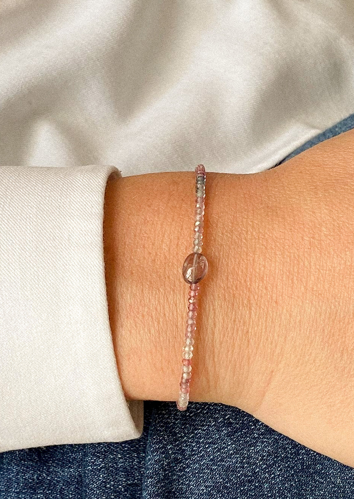 A beaded bracelet in spinel gemstones in purple tones.