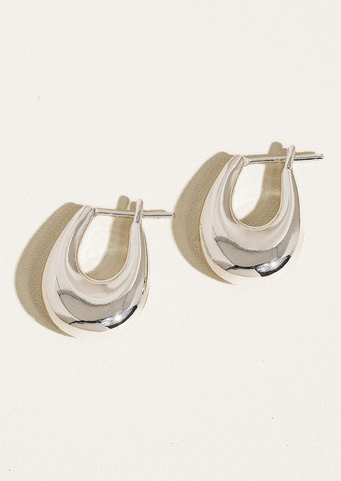 A pair of bold chunky oblong shape earrings in silver.