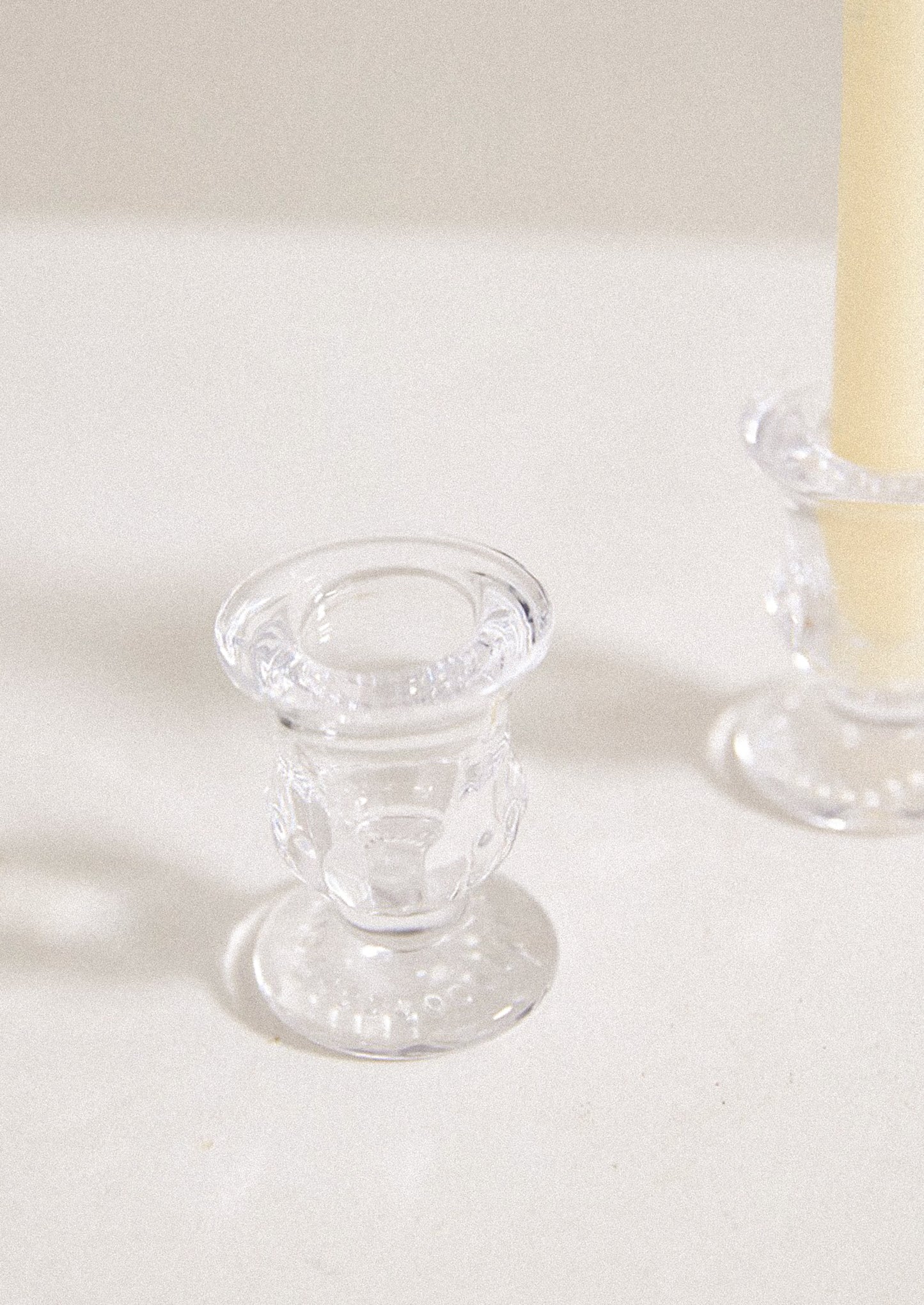 A clear glass candleholder with classic shape.