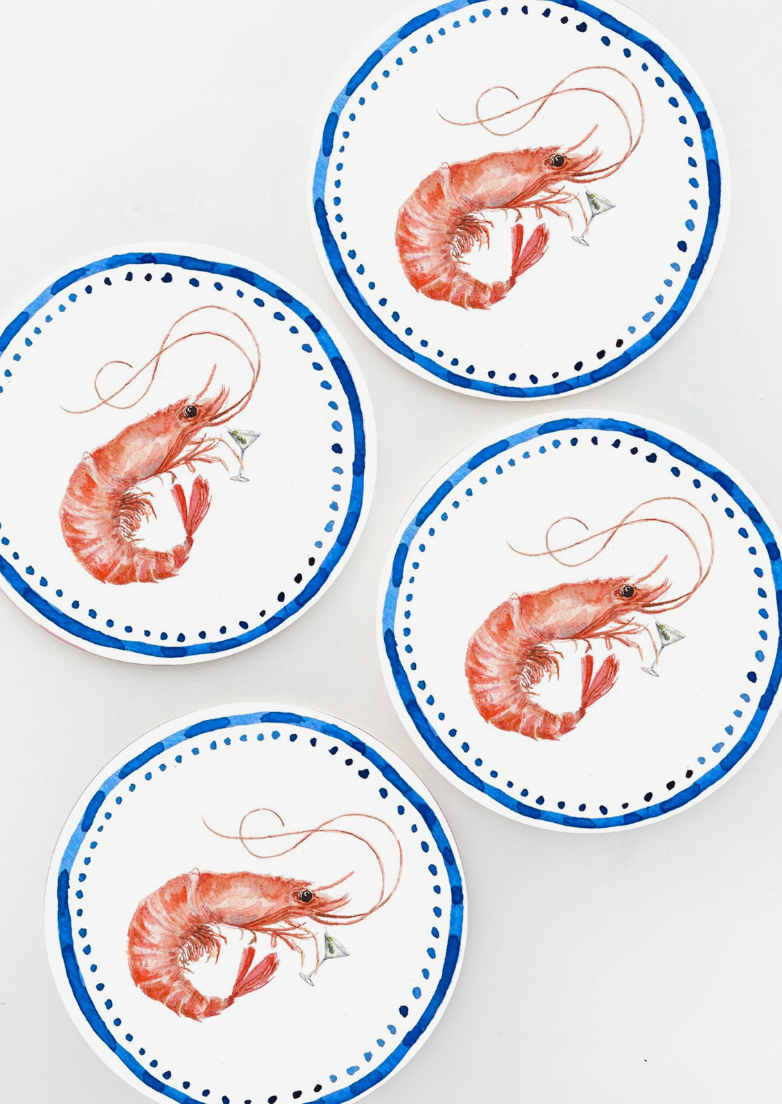 A set of four paper coasters with shrimp design.