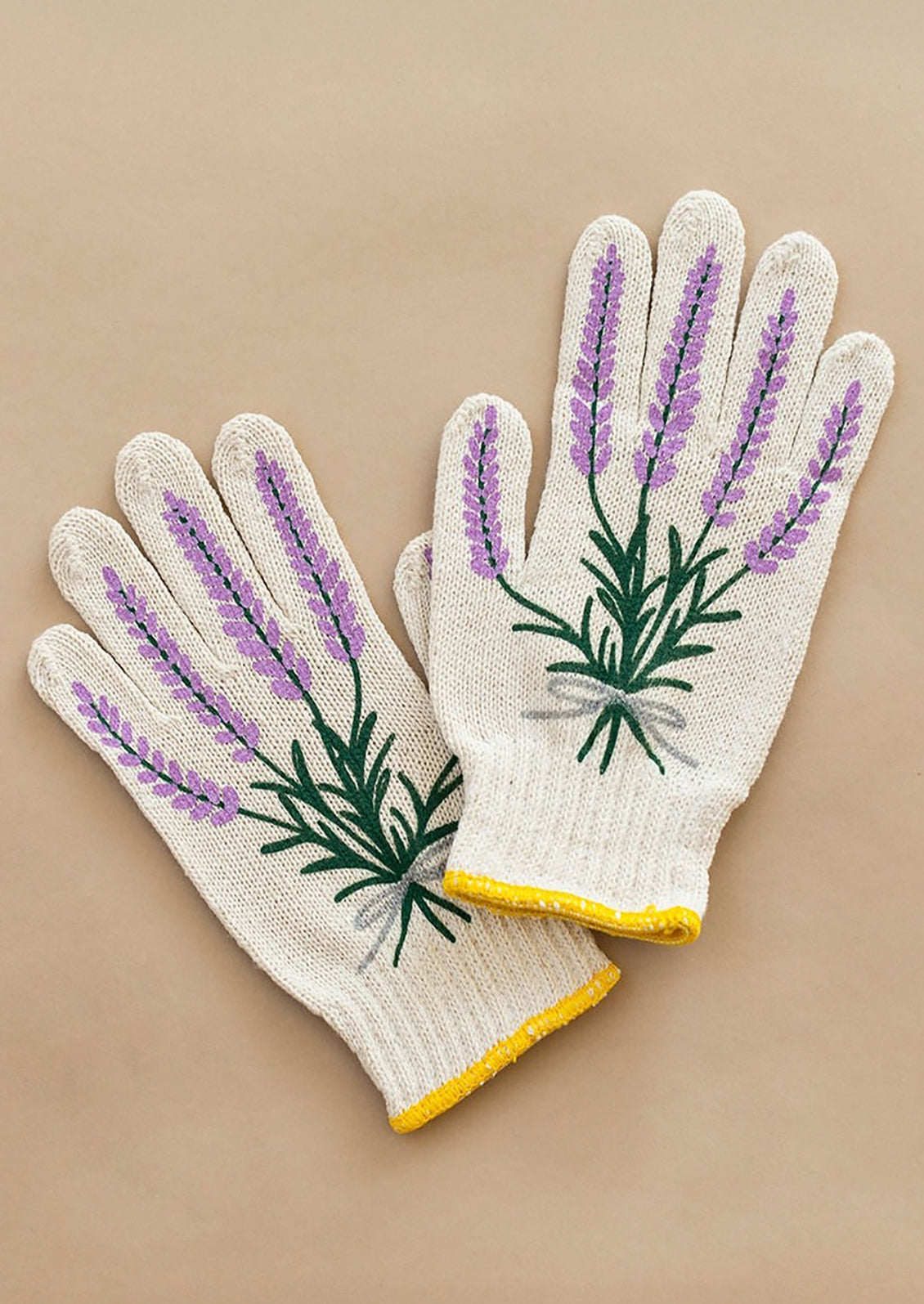 Pair of gardening gloves with lavender design on a beige background