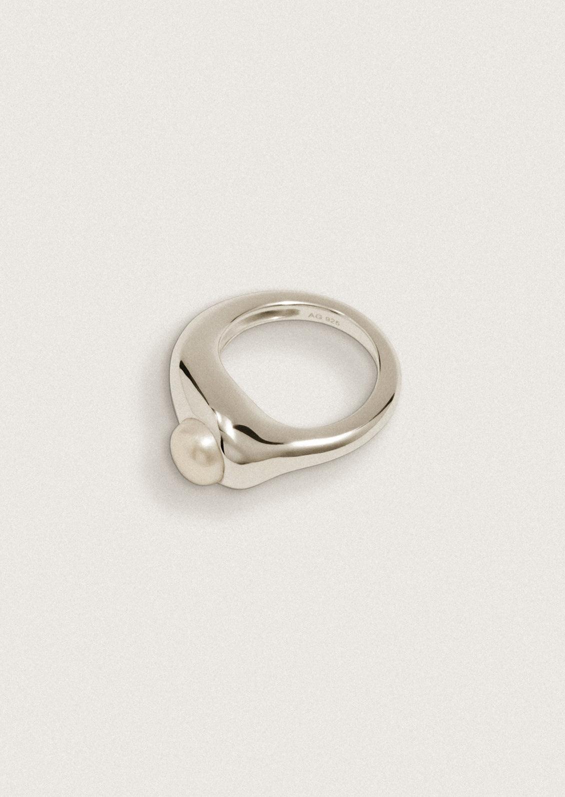 A high polish ring with pearl stone.