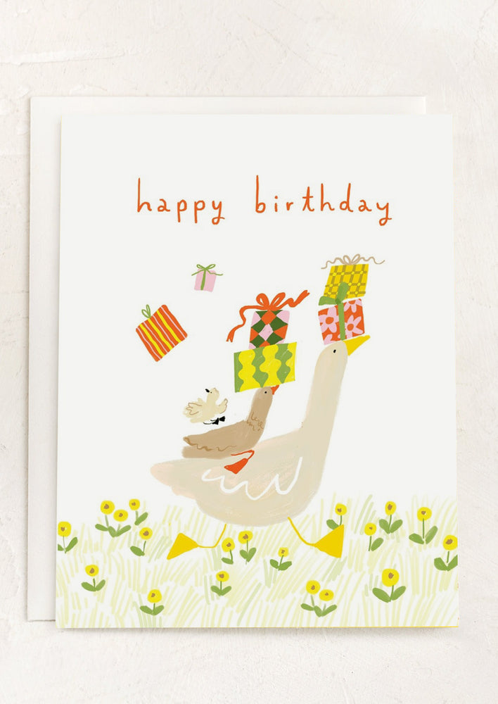 An illustrated birthday card with image of goose carrying gifts.