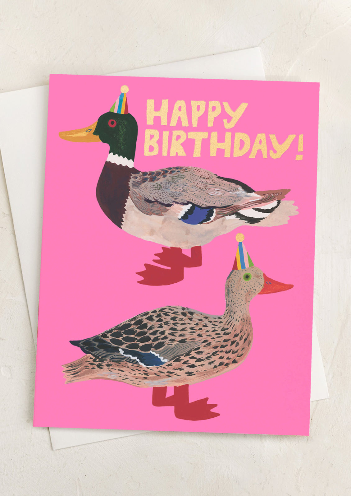 A hot pink greeting card with ducks wearing party hats, text reads Happy Birthday!