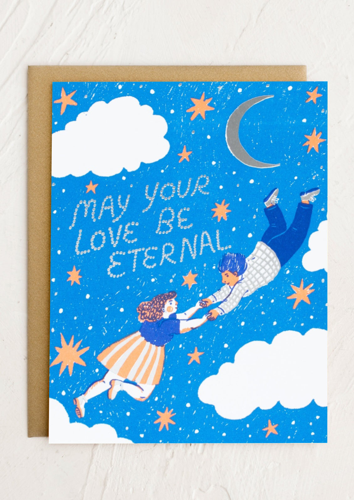 A card reading "May your love be eternal" with moon and stars print.