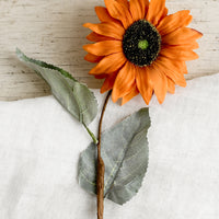1: A faux orange sunflower stem.