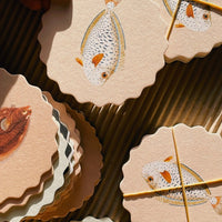 Fish: A set of scalloped edge paper coasters with 10 different fish prints.
