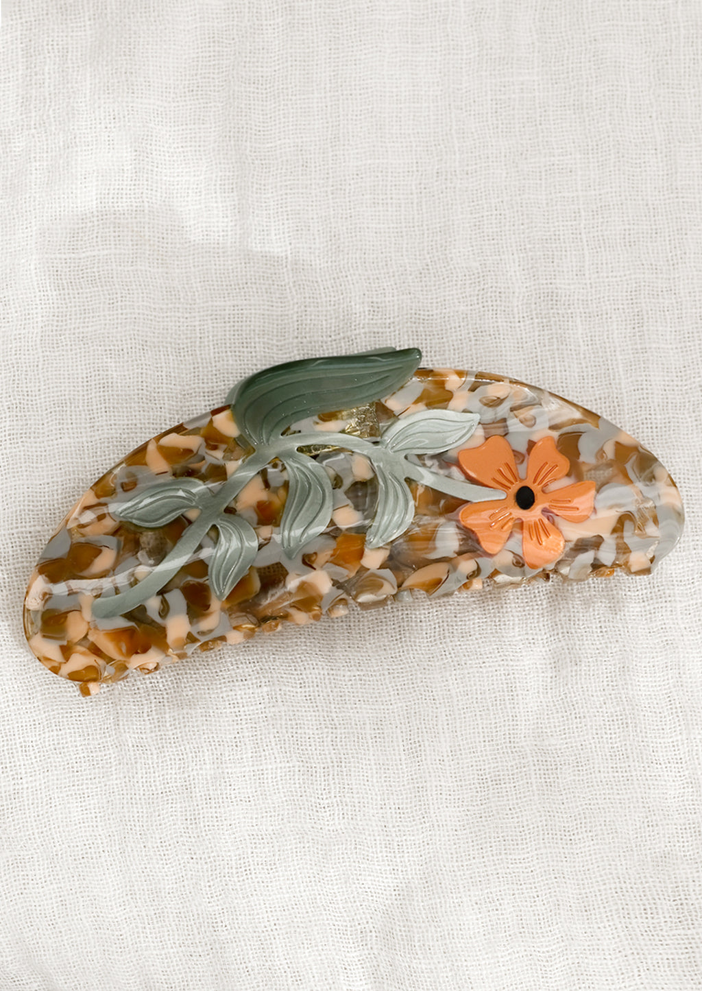 Sage Multi: A speckled acetate hair claw with orange flower.