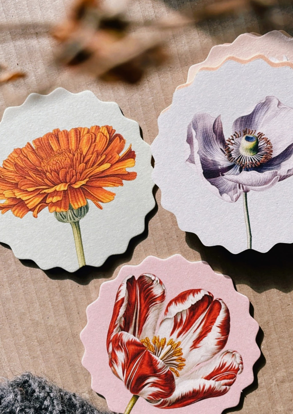7: A set of scalloped edge paper coasters with 10 different flower prints.