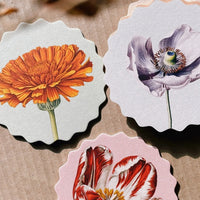 7: A set of scalloped edge paper coasters with 10 different flower prints.