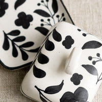 3: A black and white floral print butter dish.
