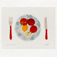 1: An art print of tomatoes and lemons on a plate with red knife and fork.