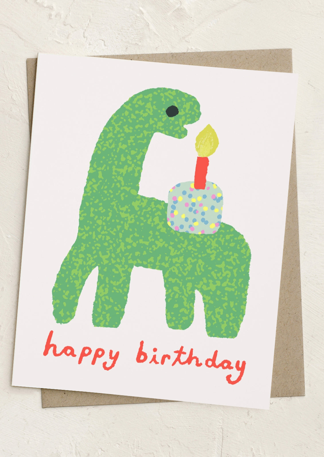 Birthday card with a green dinosaur holding a birthday cake and candle on a white background