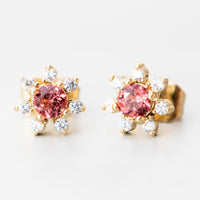 Garnet: A pair of flower shaped studs with gemstone and crystal in red.