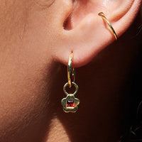 2: A pair of gold hoop earrings with garnet flower charm.