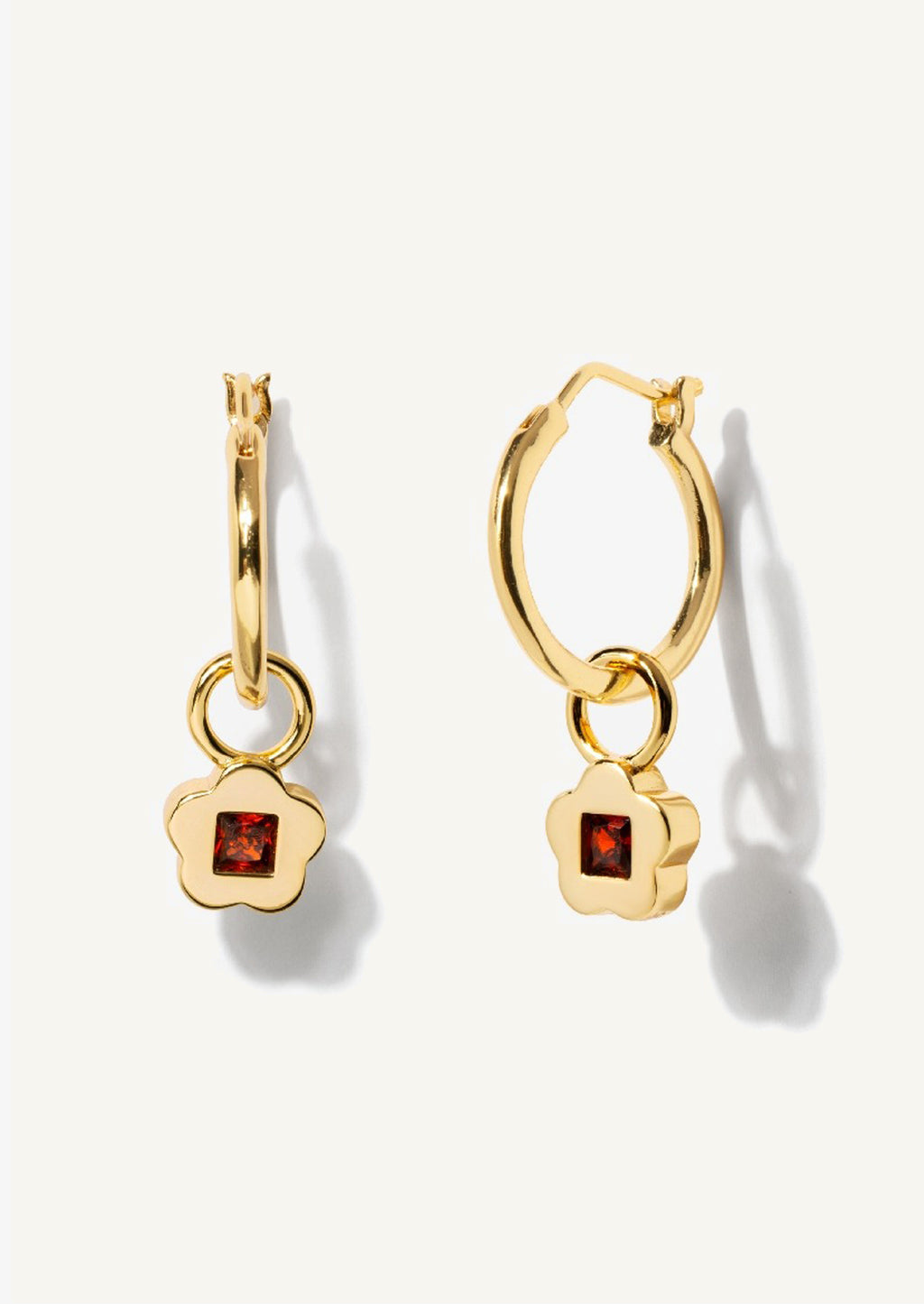 1: A pair of gold hoop earrings with garnet flower charm.