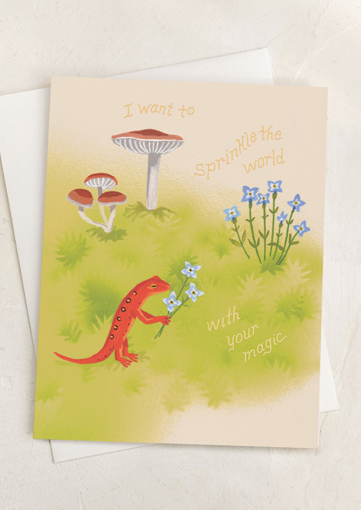 A card with image of little gecko picking flowers, text reads "I want to sprinkle the world with your magic".