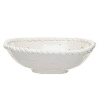 2: A white stoneware colander with twisted "rope" rim.