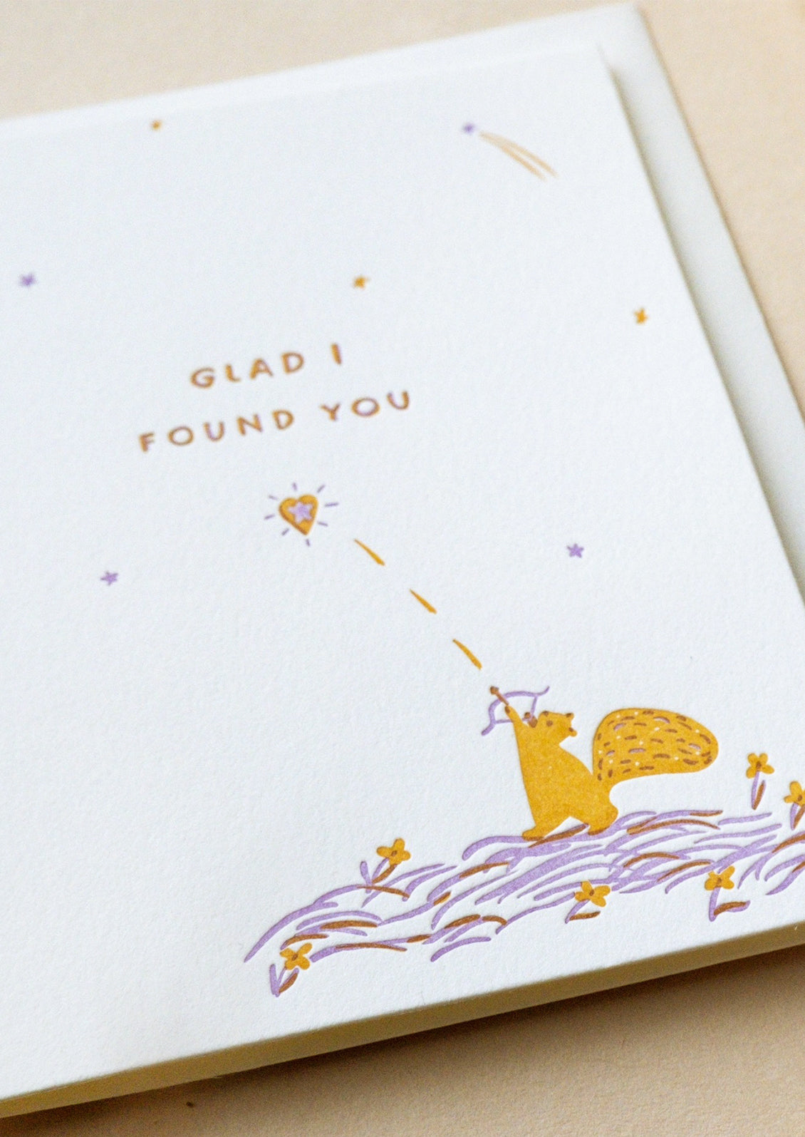 A card with illustration of squirrel shooting a heart arrow, text reads "Glad I found you".