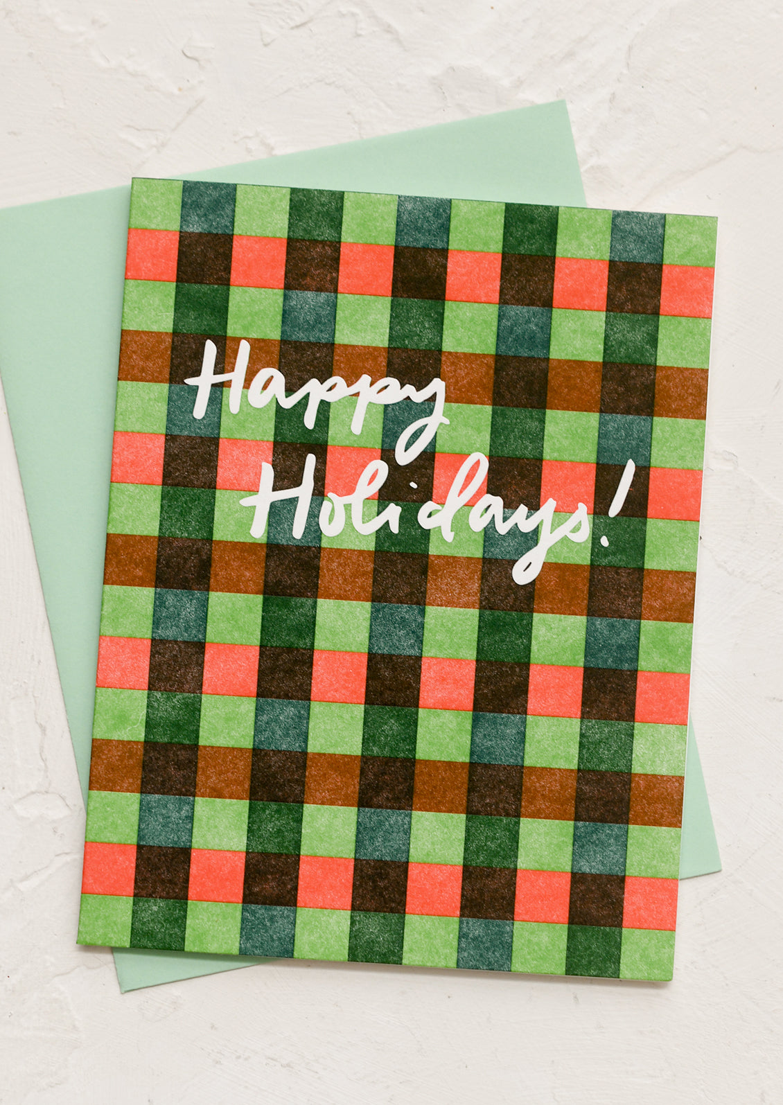 A red and green gingham patterned card, text reads "Happy Holidays!".