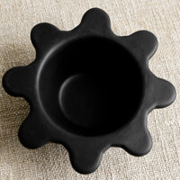 2: A small black ceramic bowl with splatter squiggle shape rim.
