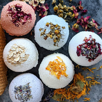 1: Colorful bath bombs with assorted dried flowers and herbs.