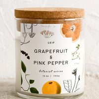 Grapefruit & Pink Pepper: A glass jar candle in Grapefruit & Pink Pepper scent with botanical print label.