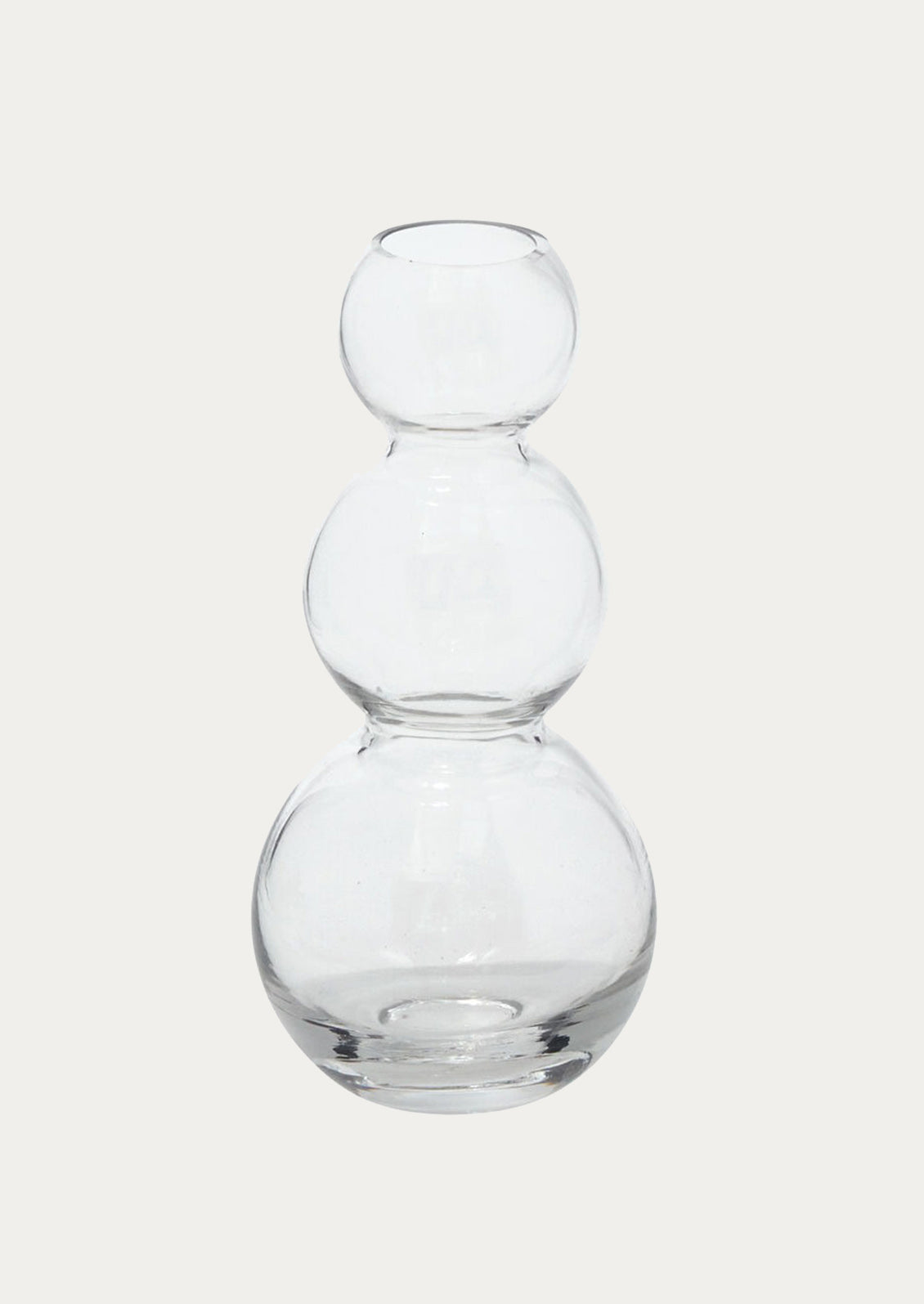 A transparent glass vase, showing off stacked round form.