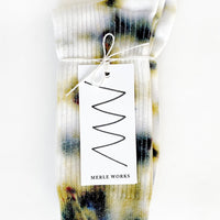 Harvest Moon: A pair of tie dye socks in white with mossy green and blue.