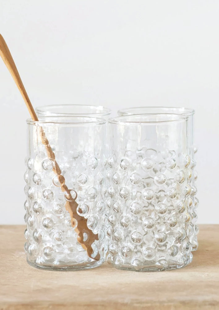 Hobnail textured tall tumbler glasses in clear glass.