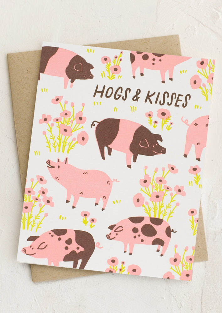 A pig print card reading "Hogs & Kisses".