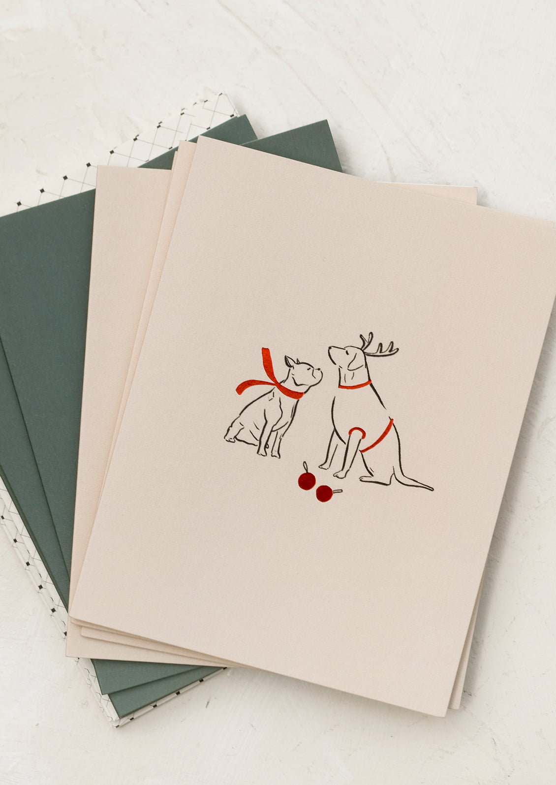 A card with illustration of two dogs wearing red scarves.