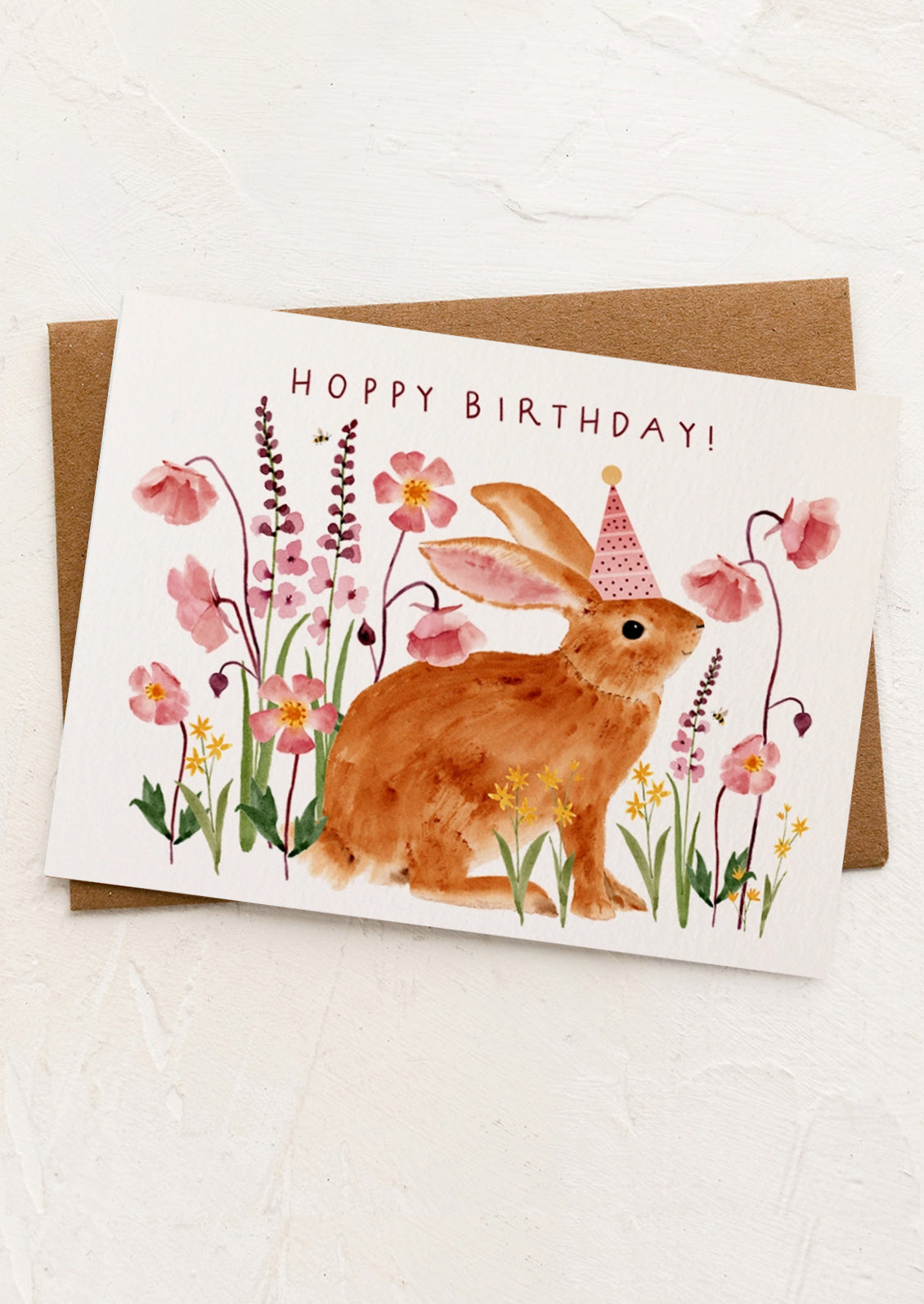 Birthday card with a rabbit and flowers on a white background
