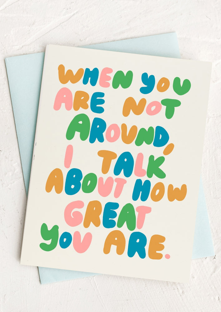 A card with multicolor letters reading "When you are not around, I talk about how great you are".