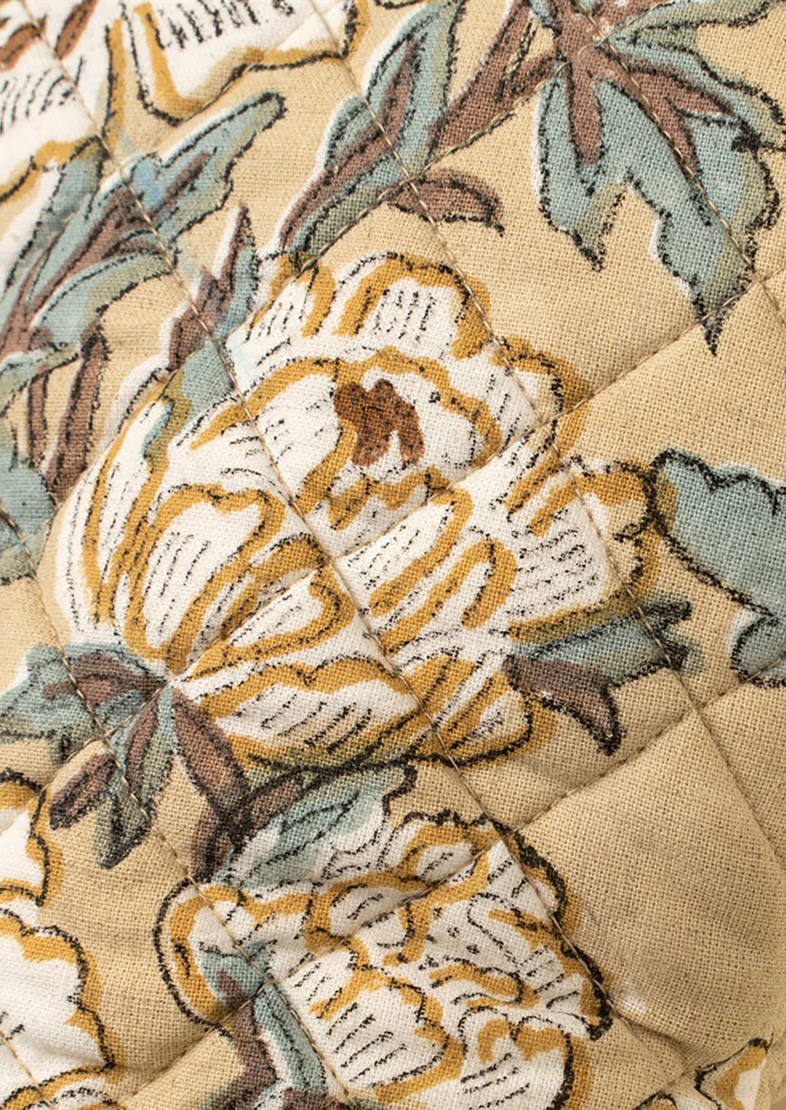 Close-up of a floral patterned fabric with beige background