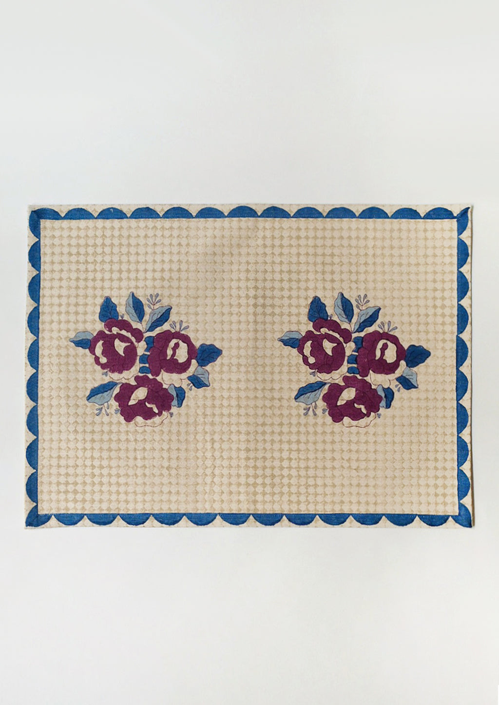 1: A block printed placemat in wine, blue and beige color palette.