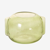 4: A transparent green glass vase in short/wide shape with side handle detail.