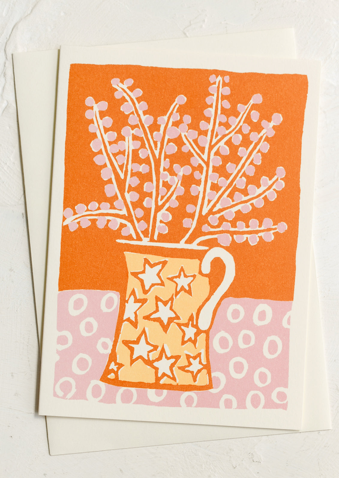 A card with colorful illustration of star print jug holding flowers.