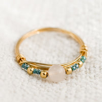 1: A gold wire ring with blue and pink beads.