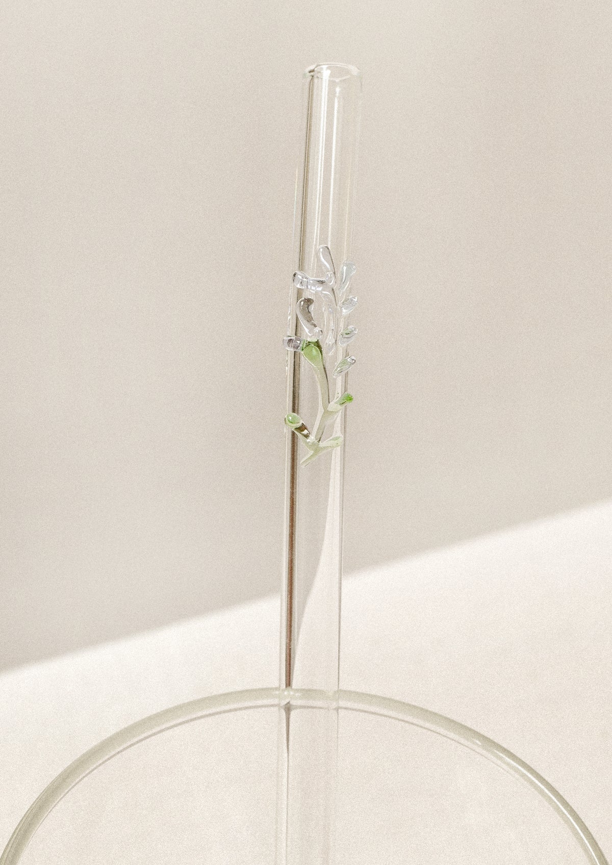 Clear glass straw with bent shape, with lampwork lavender figurine.