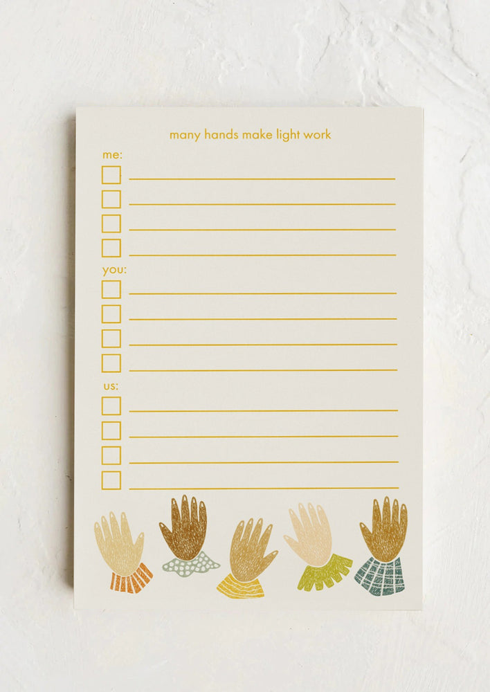 A notepad reading "Many hands make light work".