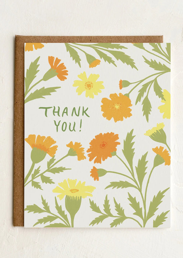 A marigold print greeting card with text reading "Thank you!".