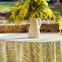 5: A block printed botanical patterned tablecloth in pastel yellow and green tones.