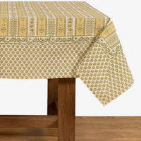 3: A block printed botanical patterned tablecloth in pastel yellow and green tones.